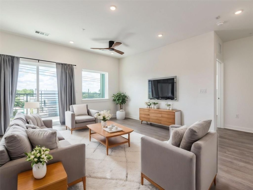 Living area featuring ceiling fan, wood finished 