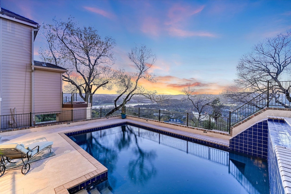 Pool at dusk featuring a fenced in pool, a patio,
