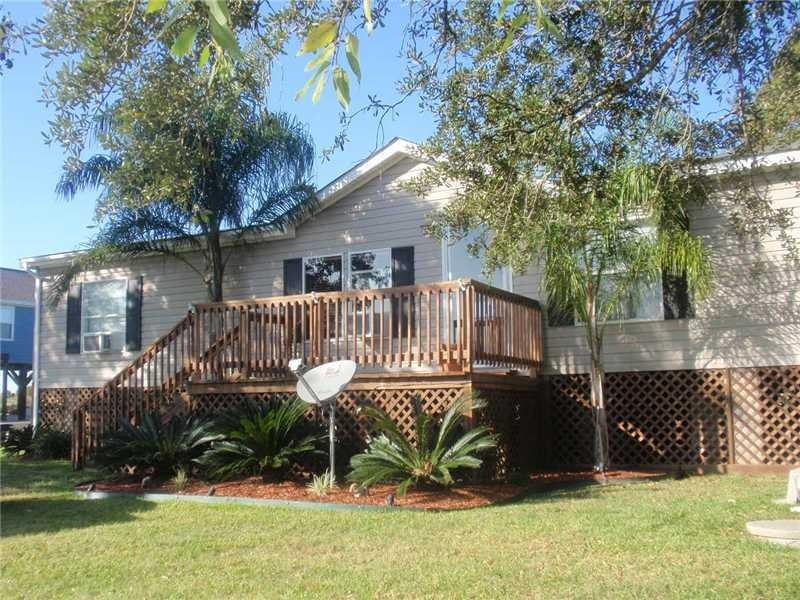 Exterior Front. Nicely landscaped, lattice work sk