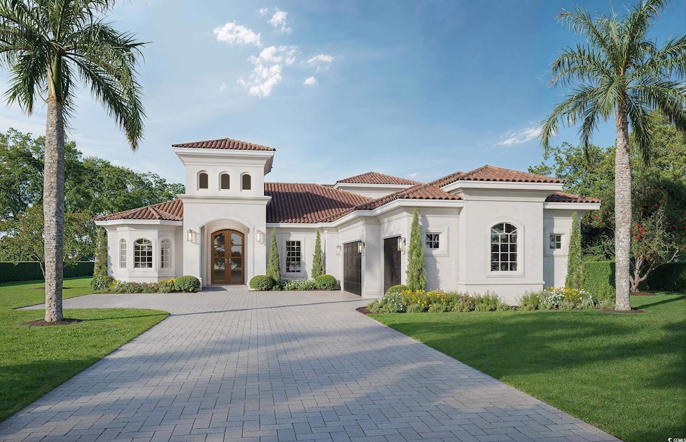 Mediterranean / spanish house featuring french doors, a front yard, decorative driveway, and stucco siding