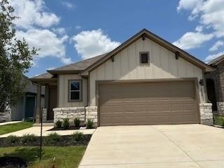 View of front of home with an attached garage, bo