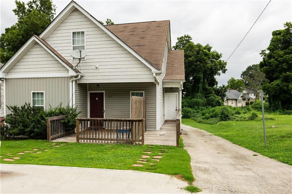 Bungalow-style house featuring a front lawn, board and batten siding, and a shingled roof
