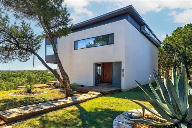 This modern construction has sleek-straight lines that enhance the natural setting surrounding the home.