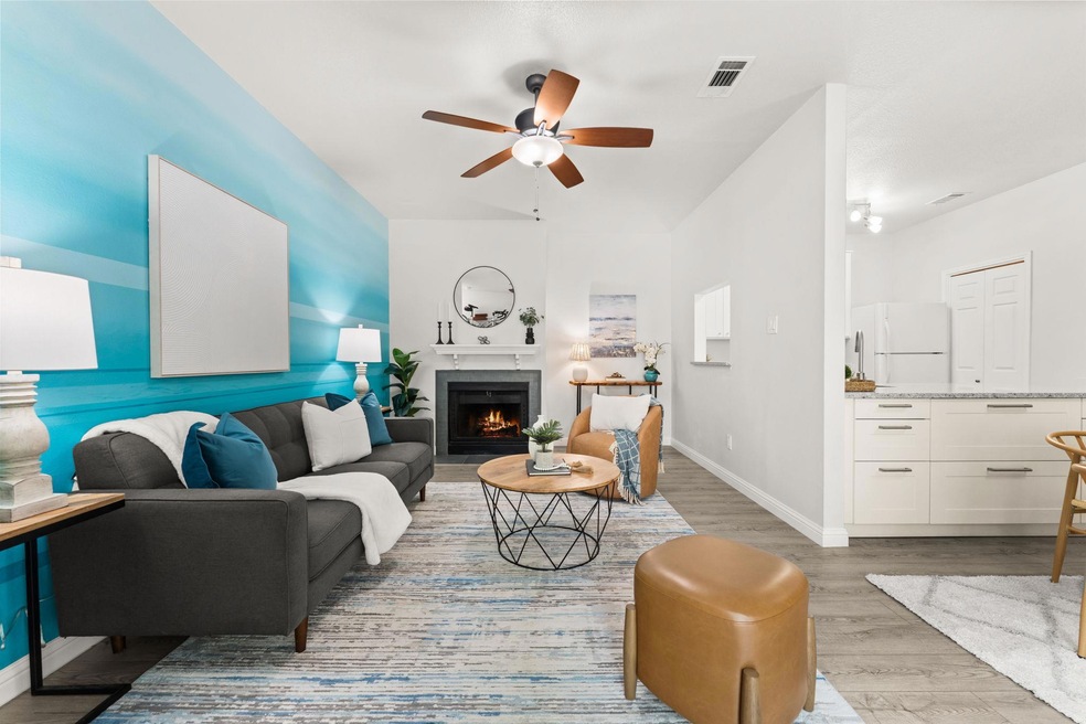 Living area featuring ceiling fan, light wood-typ