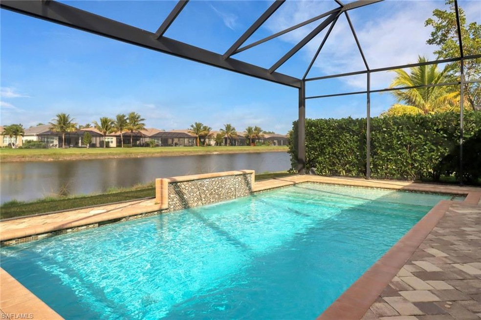 View of pool featuring a water view and glass encl