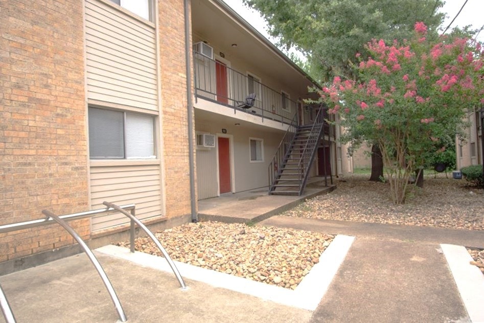 View of building exterior with stairs and a wall m