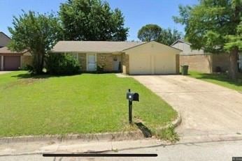 Ranch-style home featuring a front yard