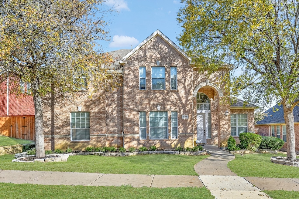 Traditional-style house featuring brick siding