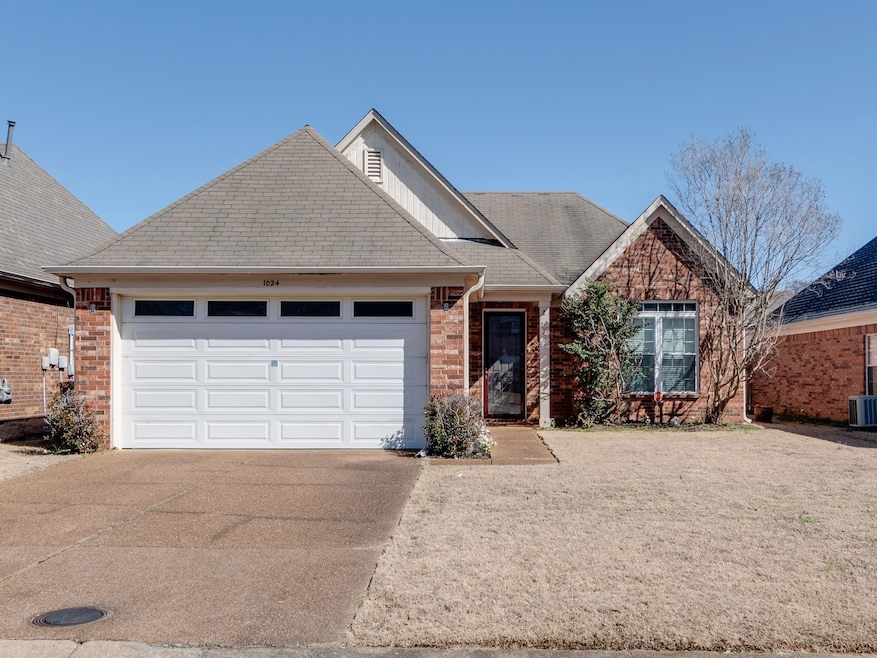 Single story home featuring driveway, a garage, a 