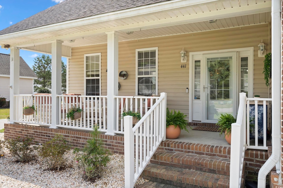 Doorway to property with a shingled roof and covered porch