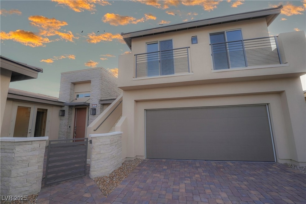 Modern home with a balcony, stucco siding, an atta