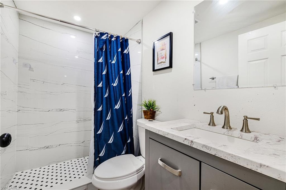 Bathroom with vanity and a shower stall