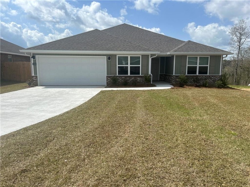 View of front facade with an attached garage, a fr