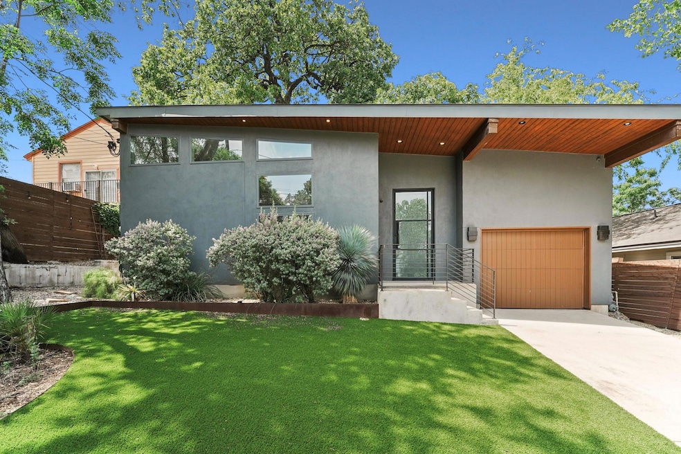 Modern home featuring driveway and stucco siding