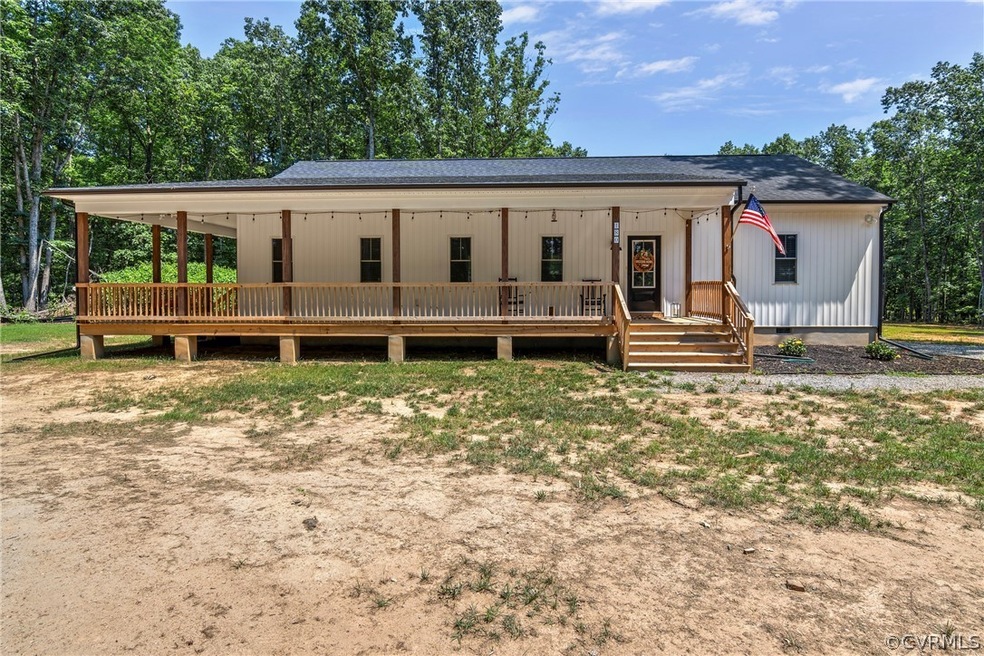 View of front of house featuring a wooden deck