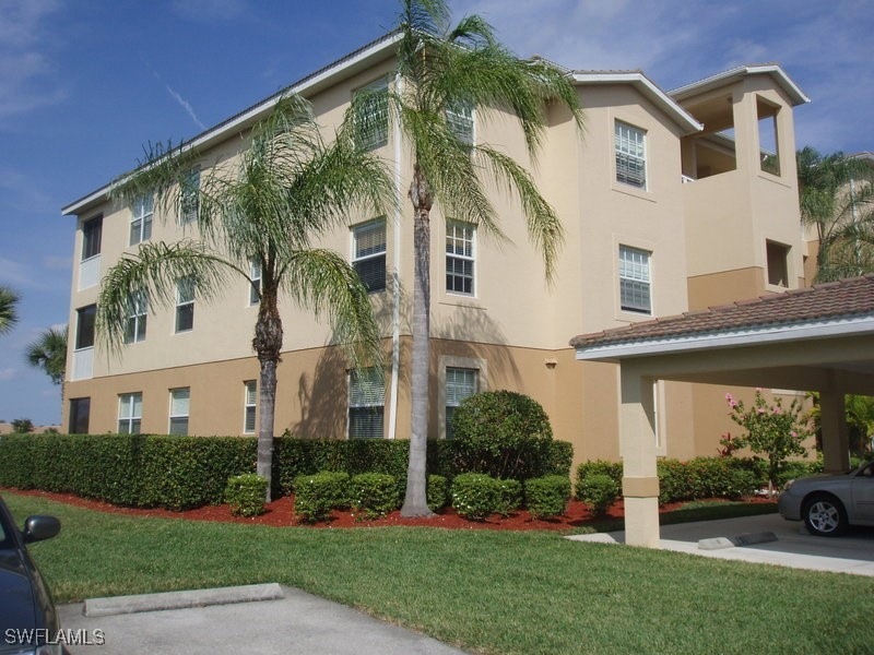 View of building exterior featuring a carport
