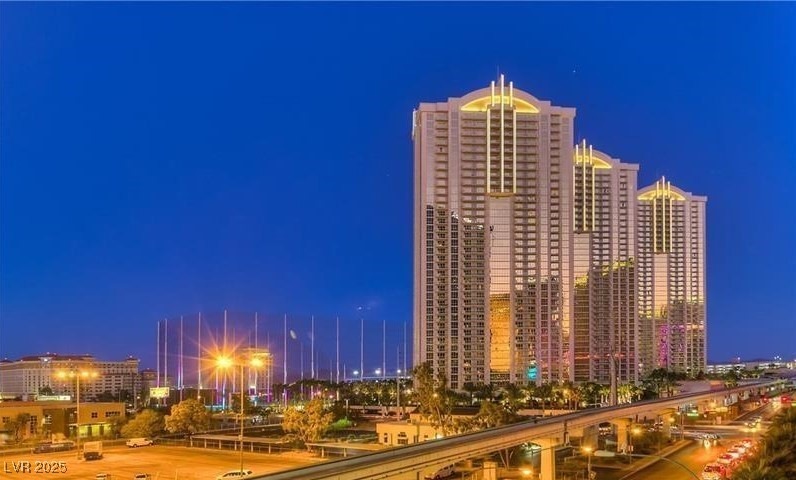 Property at night with a view of city lights