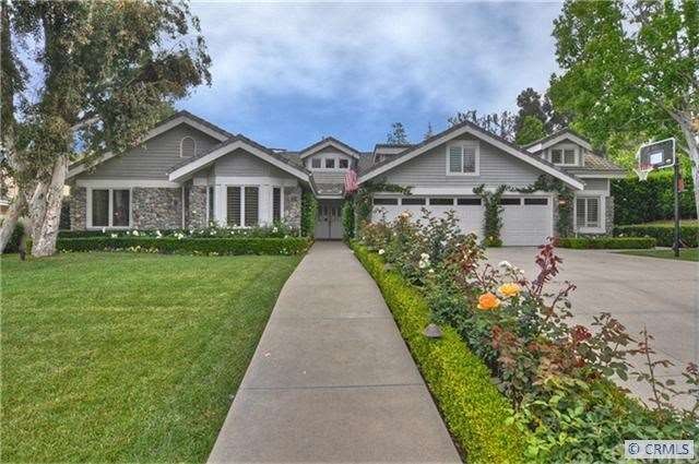 Beautiful roses lead to the front doors of this tu