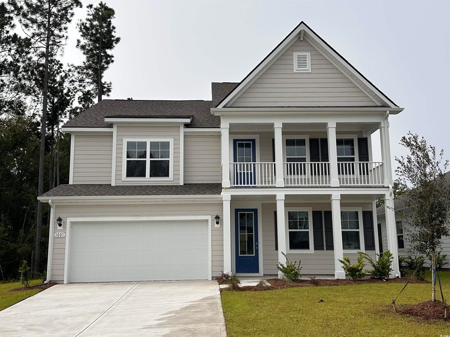 View of front of home with a garage, a front lawn,