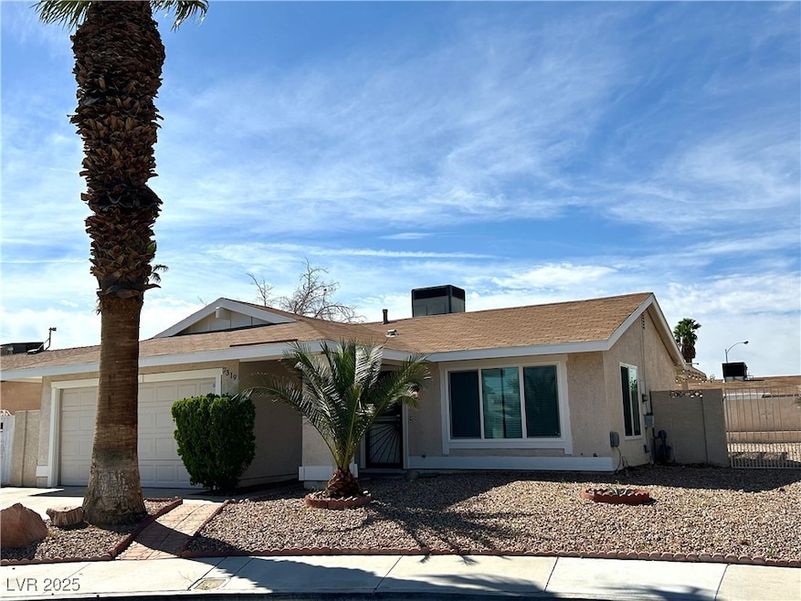 Ranch-style home with a garage and stucco siding