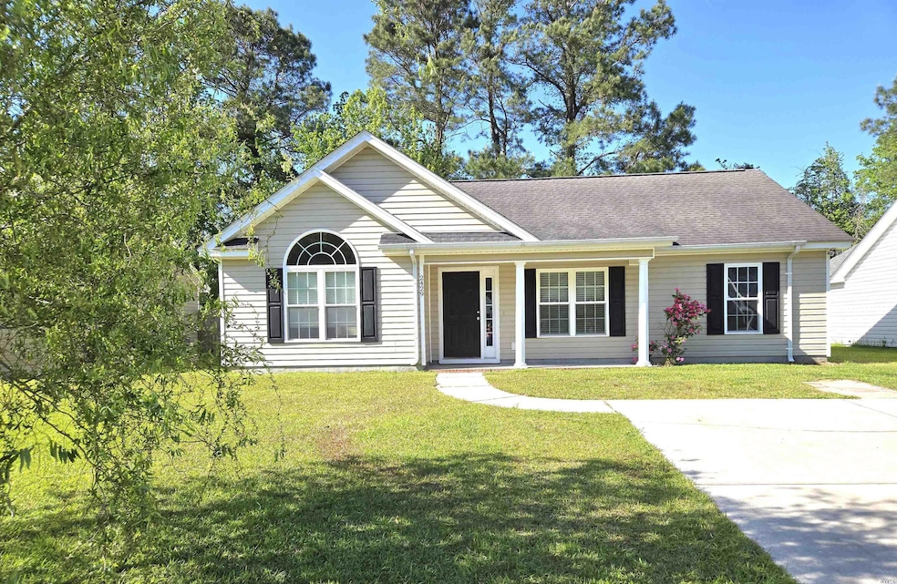 View of front facade featuring a front yard and a shingled roof