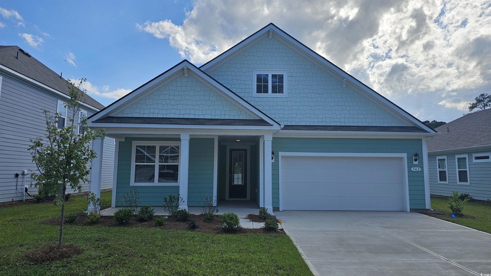 View of front facade with driveway, a front lawn, covered porch, and an attached garage