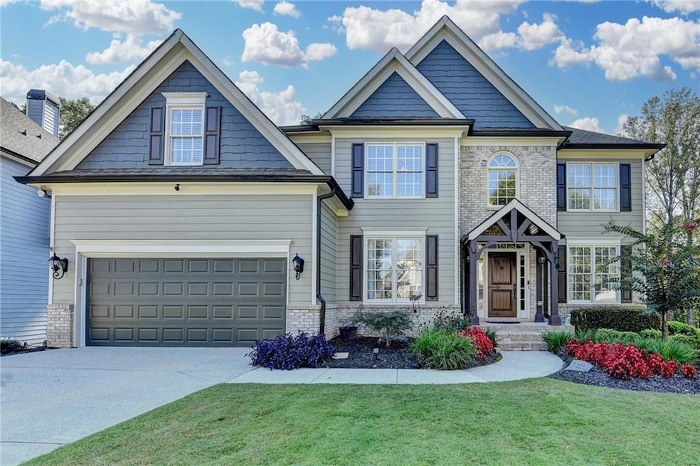 Craftsman-style home featuring a front yard, driveway, and a garage