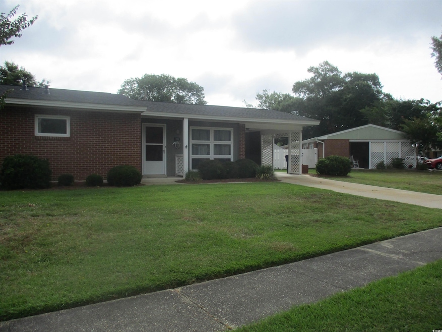 Ranch-style home featuring a front lawn