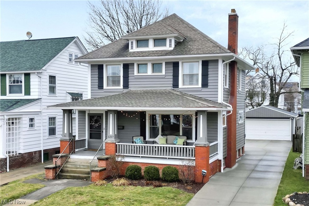 Front facade featuring a garage and covered porch