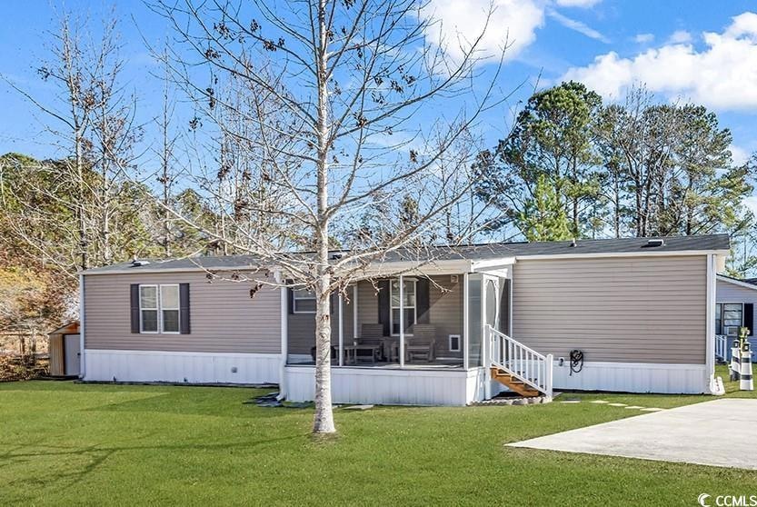 View of front of house with concrete driveway, a f