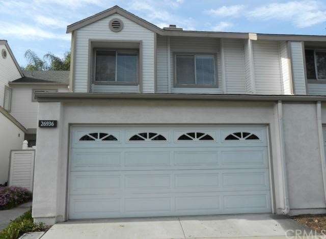 Two-car attached finished garage with rollup door.