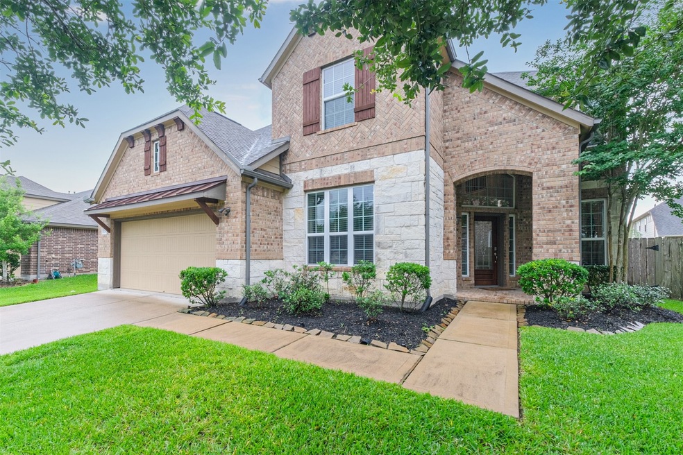 Welcome Home to lovely 12612 Colonial Glen in Southern Trails! The front elevation features brick and limestone with wood shutters and corbels for accents.