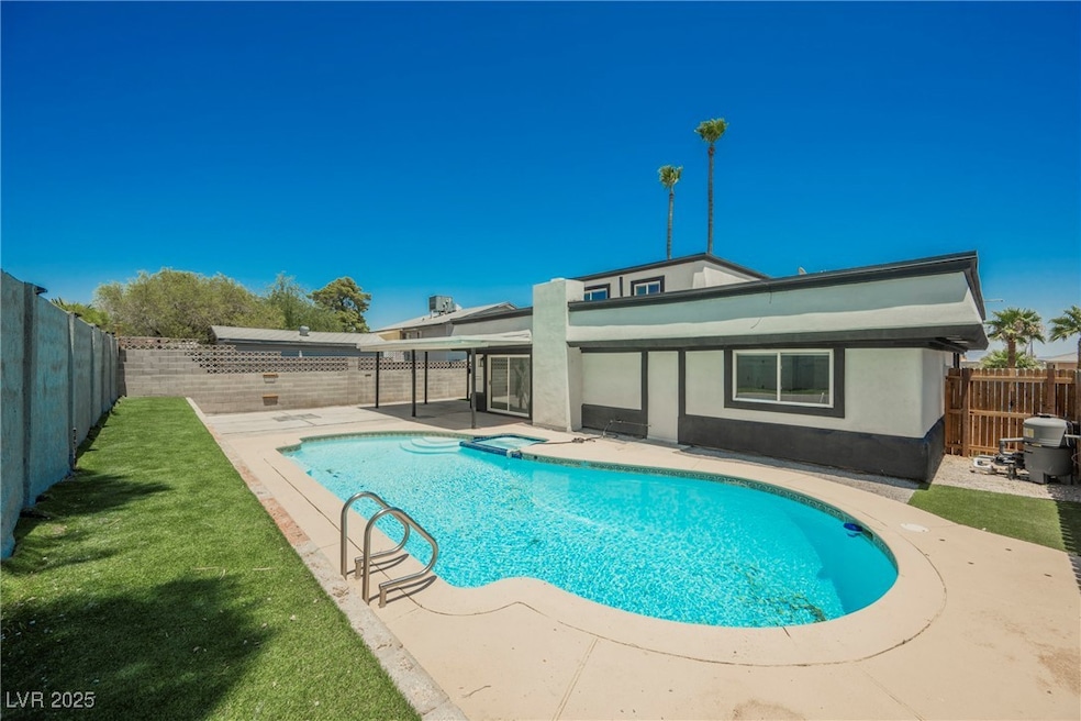 View of swimming pool featuring a patio, a fenced