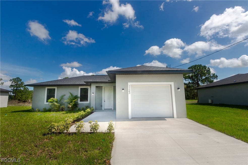 Single story home featuring stucco siding, drivewa