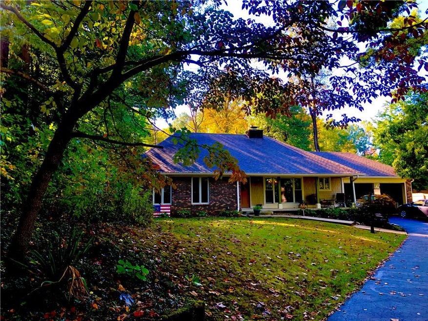 The lot is huge there is a circular asphalt driveway surrounded by nature ! The garage is extra large two cars. 
