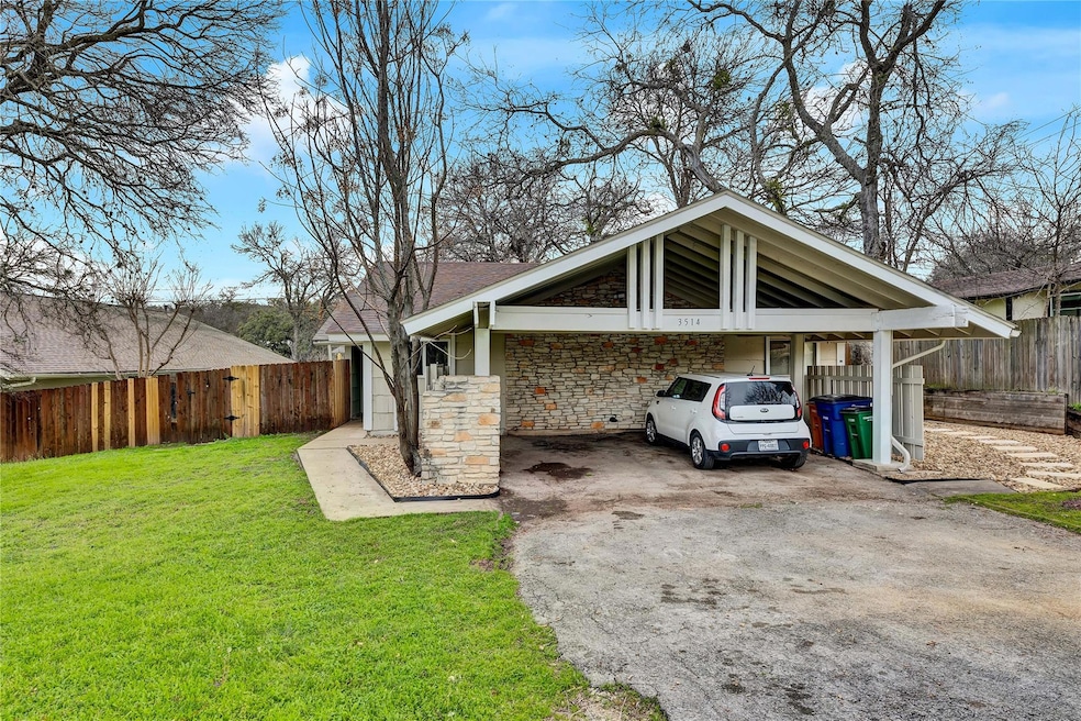 View of parking featuring driveway and a carport