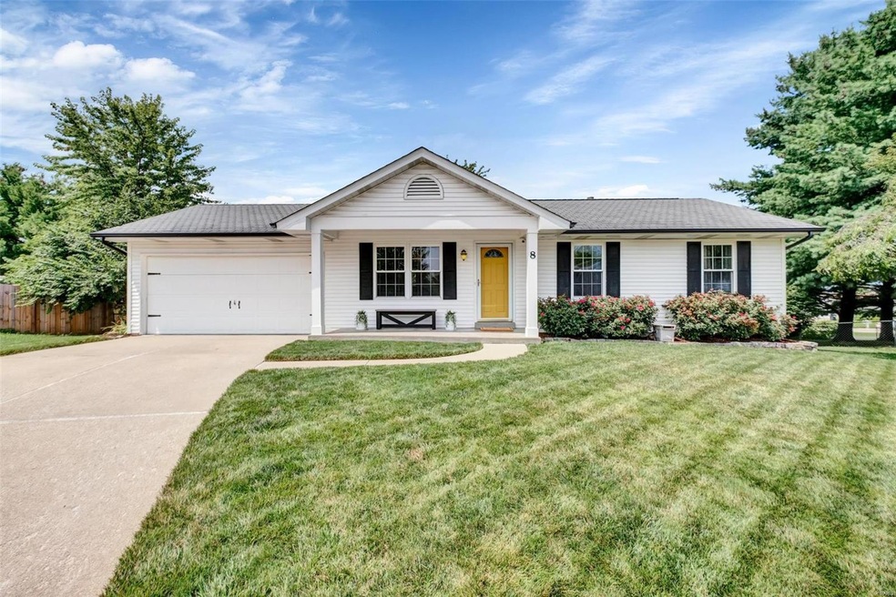 The adorable curb appeal continues inside!  Don't miss the easy-care vinyl siding and lovely landscaping surrounding the covered porch!