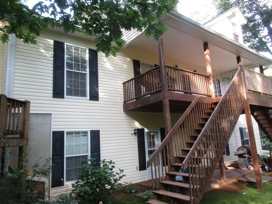 FRONT OF HOME WITH LARGE COVERED PORCH .  PRIVATE ENTRANCE BELOW TO APARTMENT.