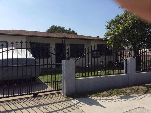 Front of home from street scene. Rod iron gated ho