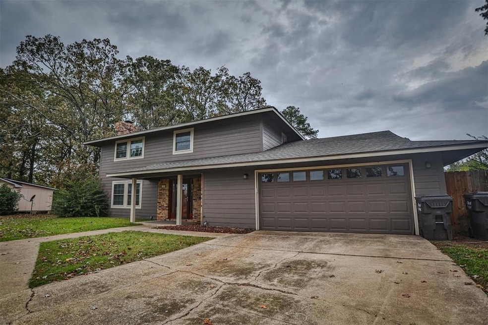 Front of property with a garage and a front yard