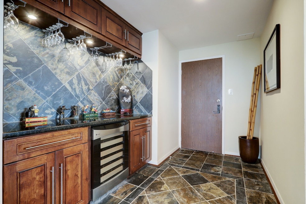 Entry hall with built-in bar area makes for entert