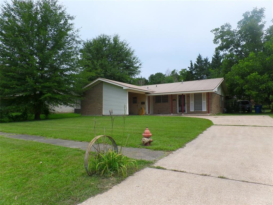 Located on a large corner lot with a metal roof