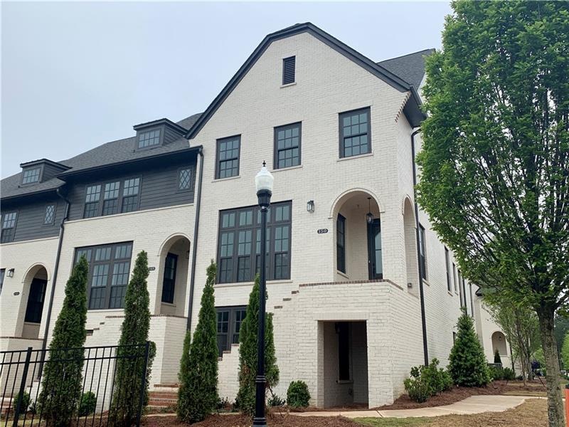 Gorgeous END UNIT townhome with a classic cream pa