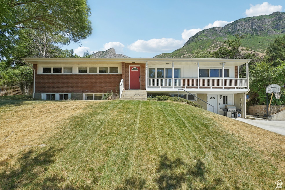 View of front of home featuring a mountain view and brick siding