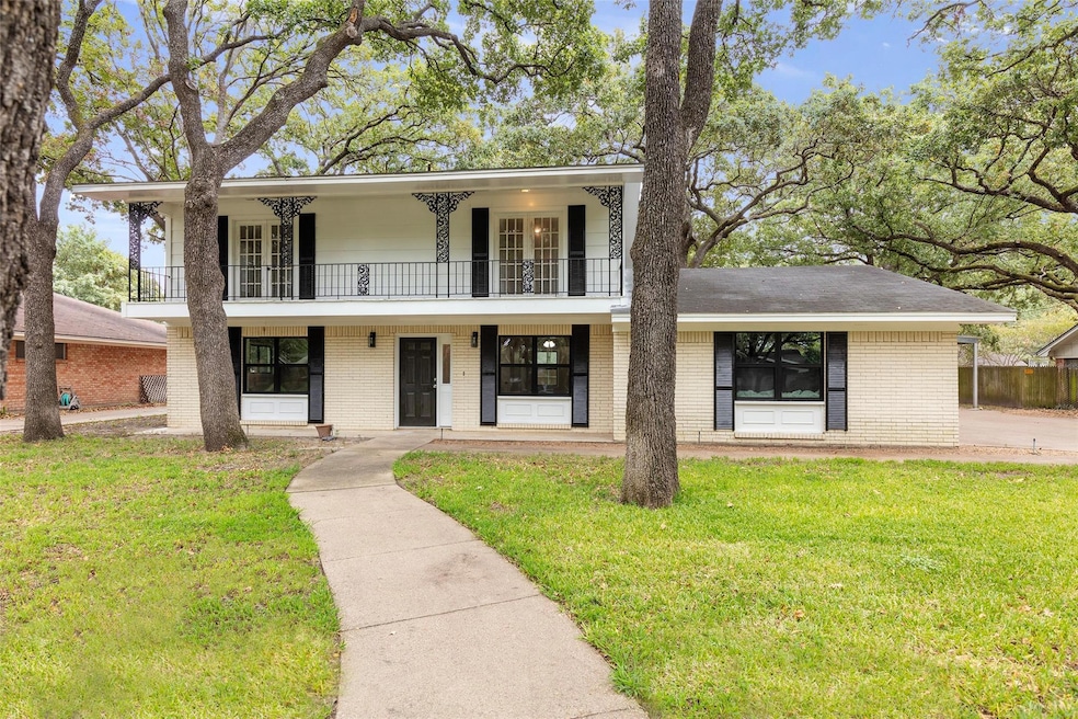 View of front of property with a balcony, covered porch, and a front lawn