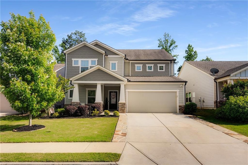 Craftsman-style home with driveway, a front lawn, 