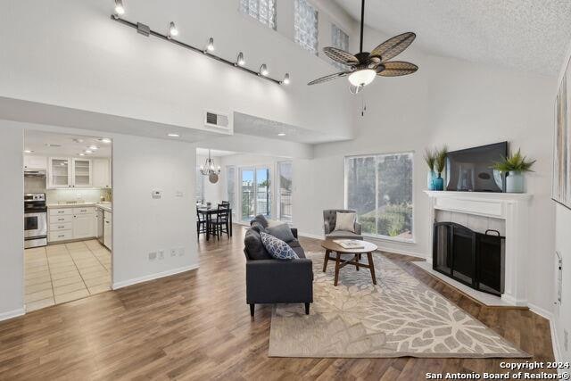 Living room featuring a tile fireplace, a ceiling