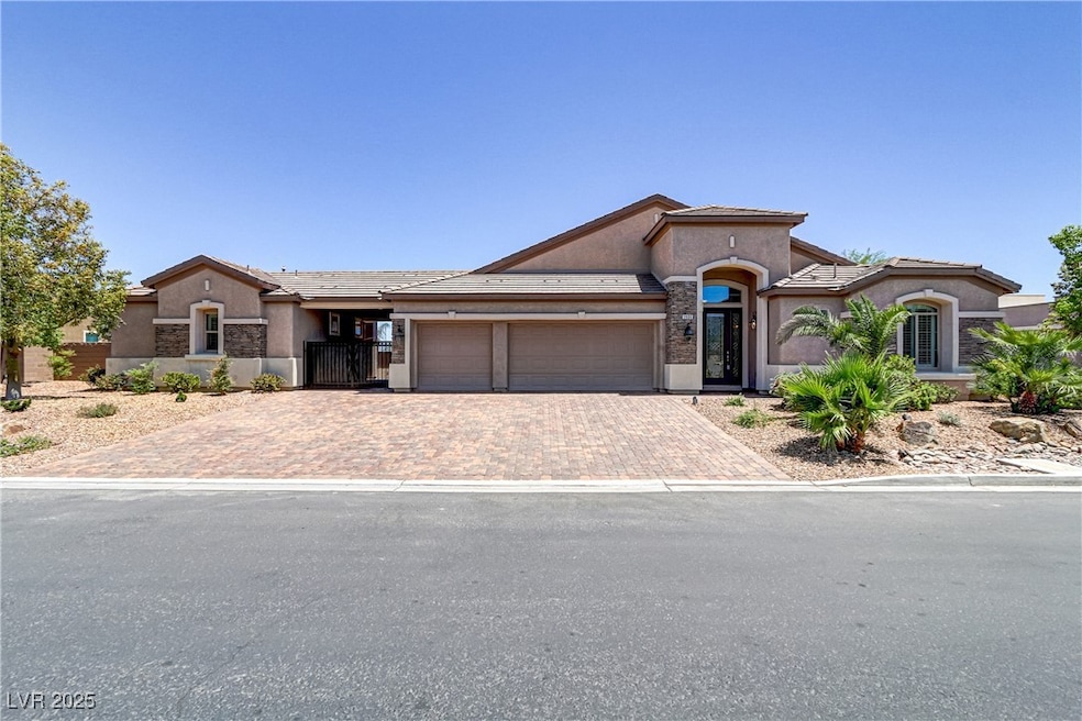 View of front facade with a garage, stucco siding,