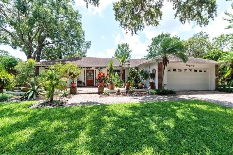 FRONT VIEW WITH PAVER COURTYARD AND DRIVEWAY