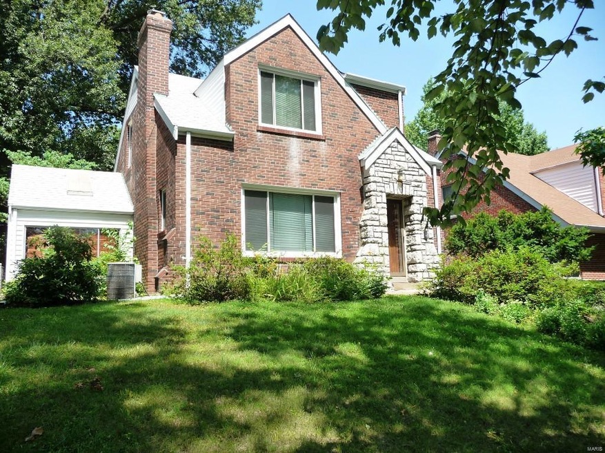 Primarily brick and stone 2 story home with sun ro